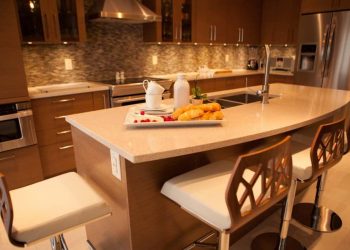 Custom kitchen with island, Quartz top, microwave drawer and chimney hood