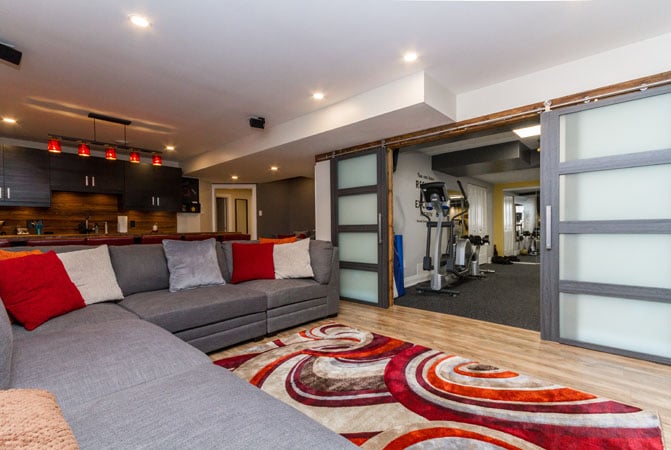 Downstairs Living in Style - Entertainment area with sliding door to gym