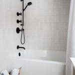closeup of black fixtures in combo bath and shower