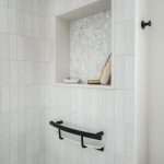 closeup of inset shower shelf and shampoo shelf grab bar