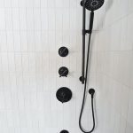 closeup of black fixtures in combo bath and shower