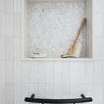 closeup of inset shower shelf and shampoo shelf grab bar from inside tub