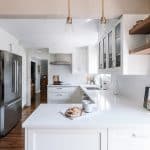 Wall-mount double ovens and a French door fridge really open up the space